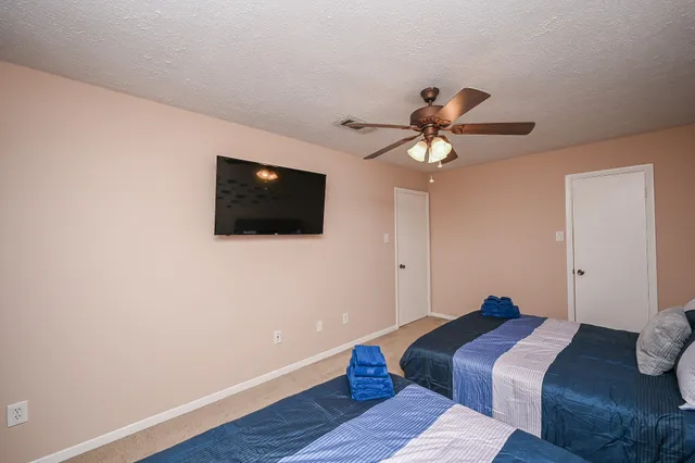 a bathroom with a granite countertop toilet sink and mirror