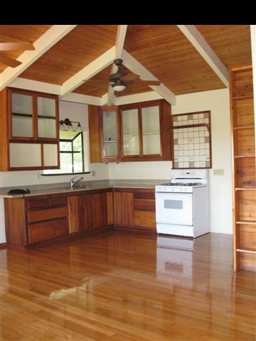 16 Hea'aula Haiku, HI 96708 - Photo 4 of 30 a kitchen with stainless steel appliances granite countertop a stove and a wooden cabinets