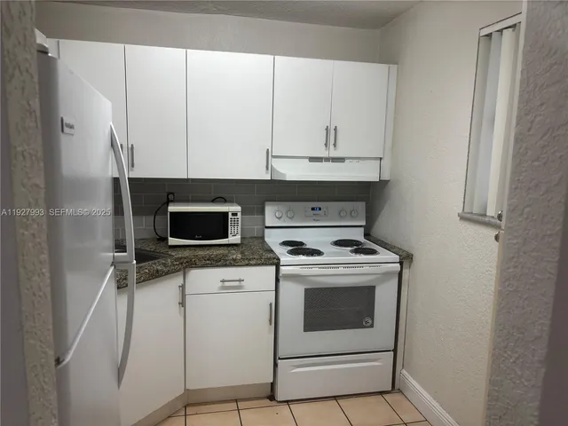 a kitchen with a stove and a microwave