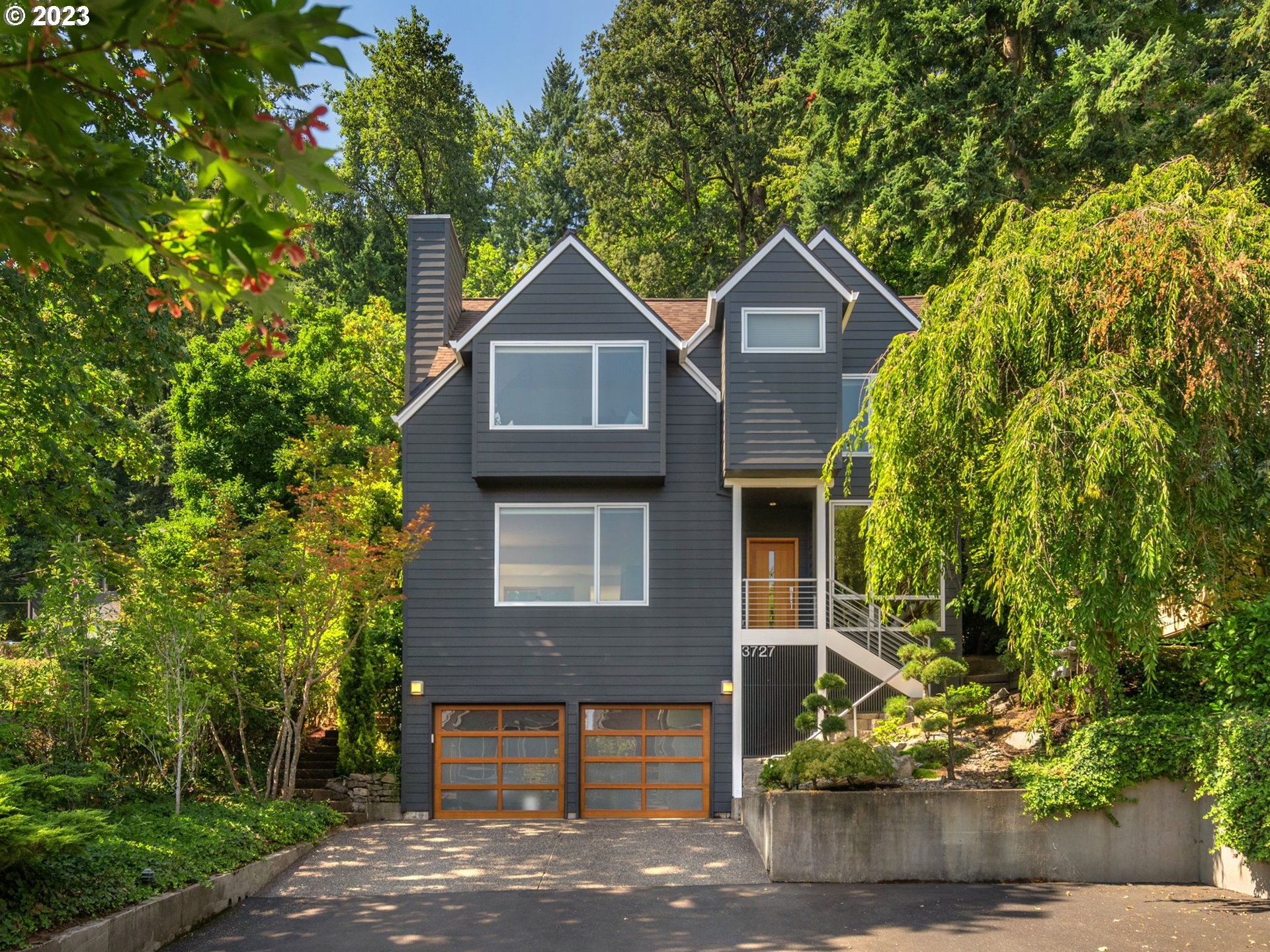 3727 Southwest Condor Lane Portland, OR 97239 - Photo 1 of 33 a front view of a house with a yard and garage