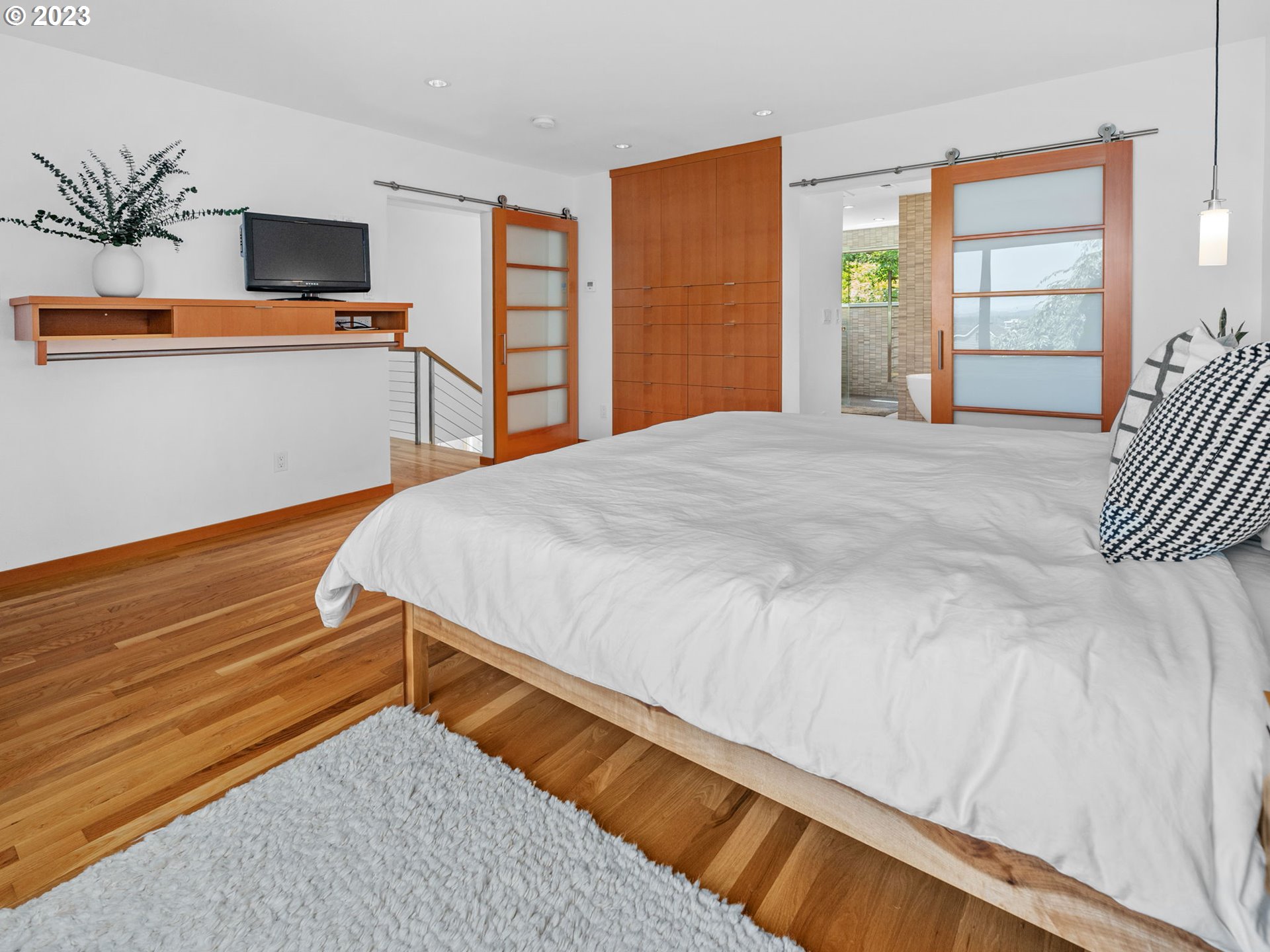 3727 Southwest Condor Lane Portland, OR 97239 - Photo 14 of 33 a bedroom with a bed and a flat screen tv