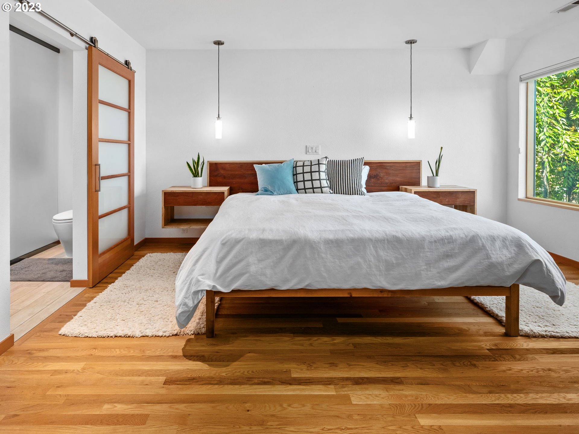 3727 Southwest Condor Lane Portland, OR 97239 - Photo 15 of 33 a bedroom with a bed and wooden floor