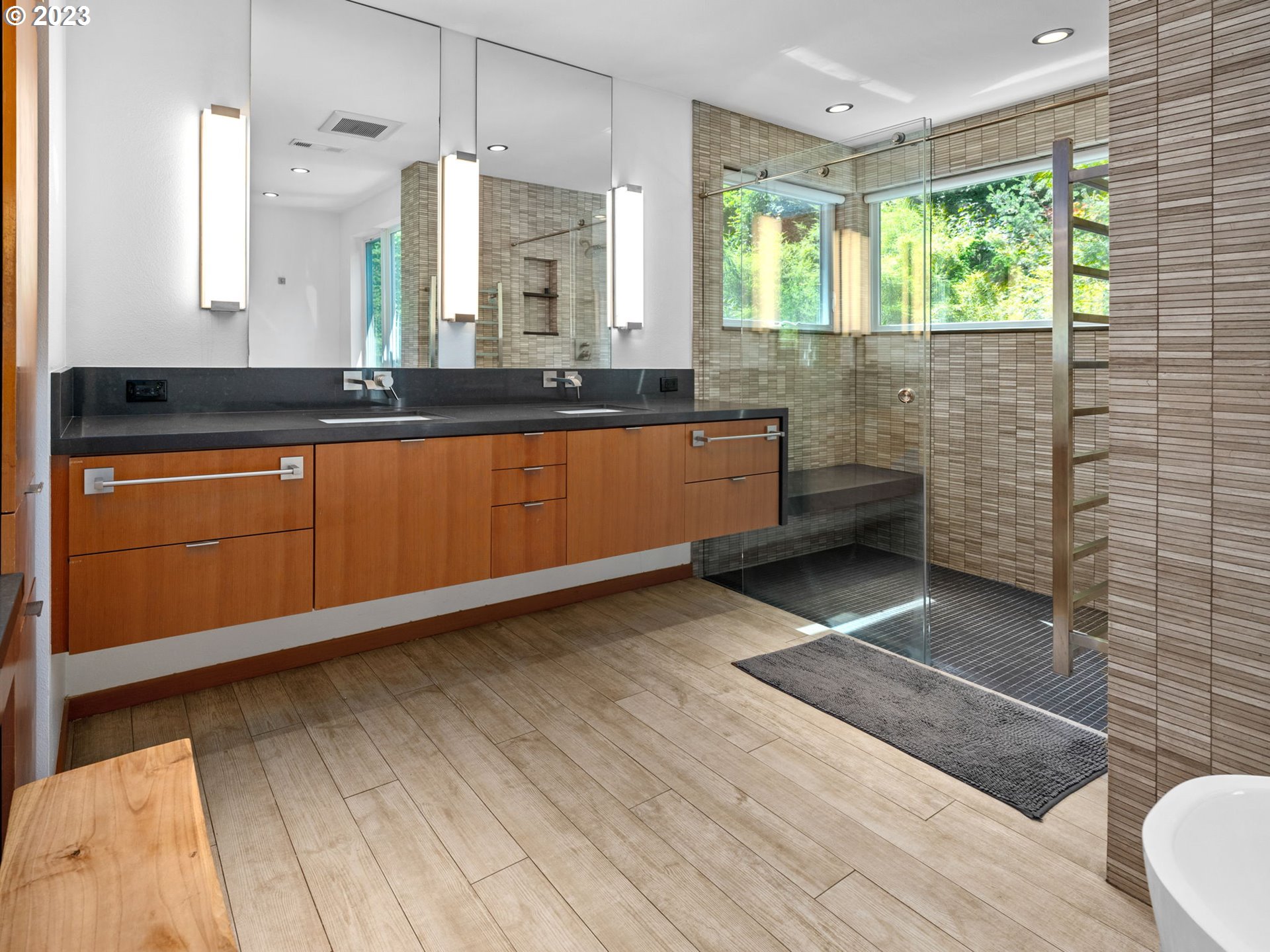 3727 Southwest Condor Lane Portland, OR 97239 - Photo 18 of 33 a bathroom with a sink a mirror and a shower