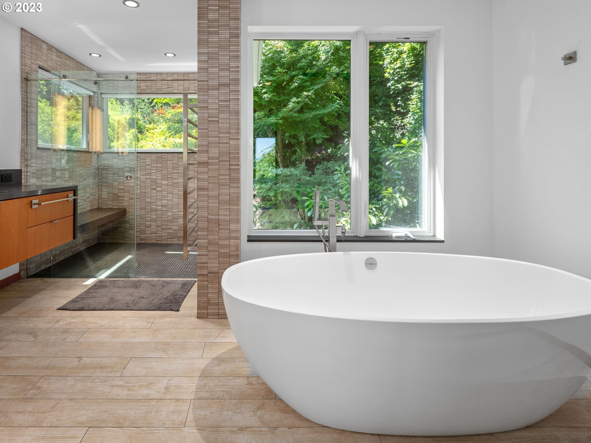 3727 Southwest Condor Lane Portland, OR 97239 - Photo 19 of 33 a white bath tub sitting in a bathroom next to a window