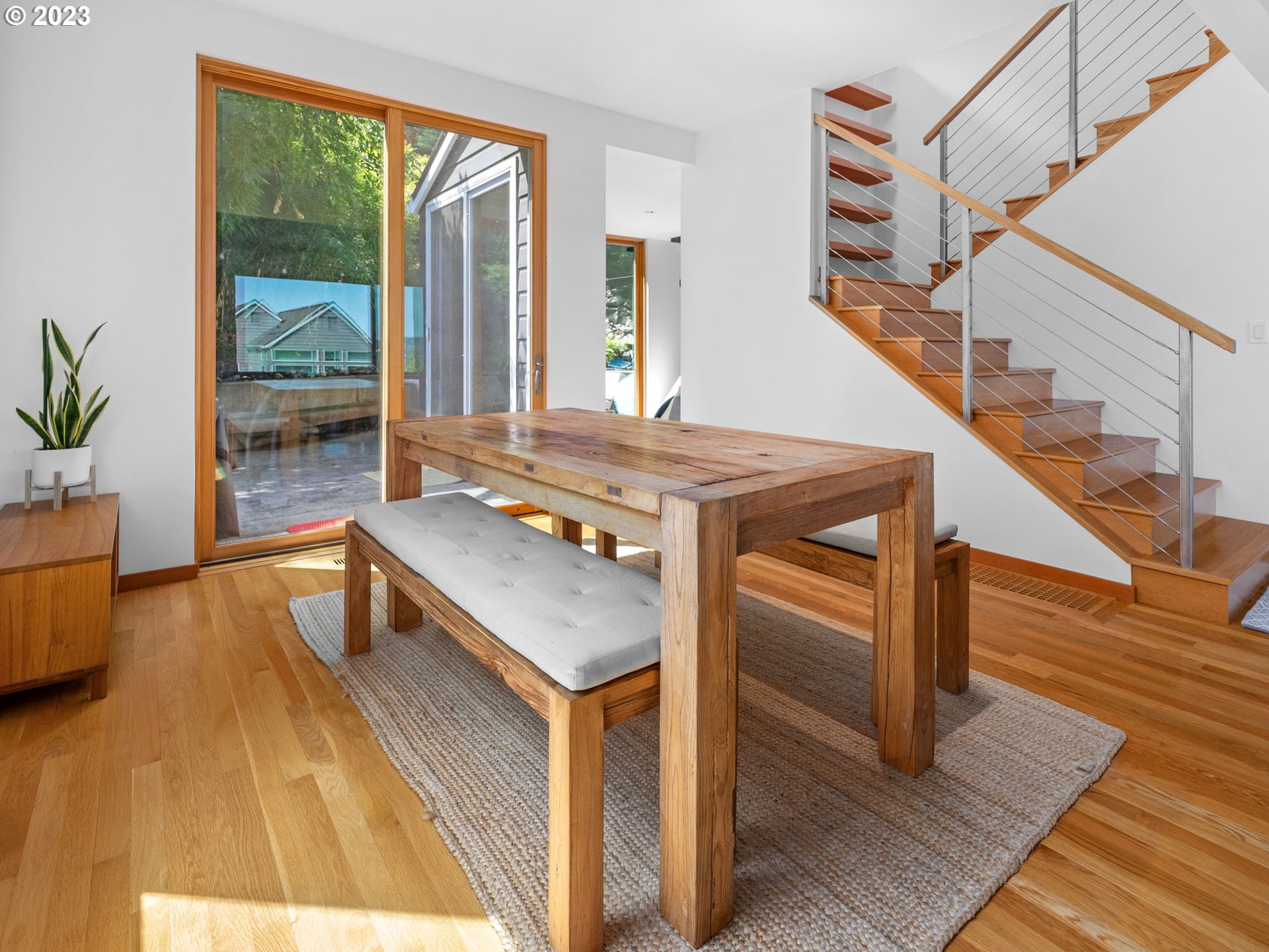 3727 Southwest Condor Lane Portland, OR 97239 - Photo 6 of 33 a living room with a table wooden floor and a large window