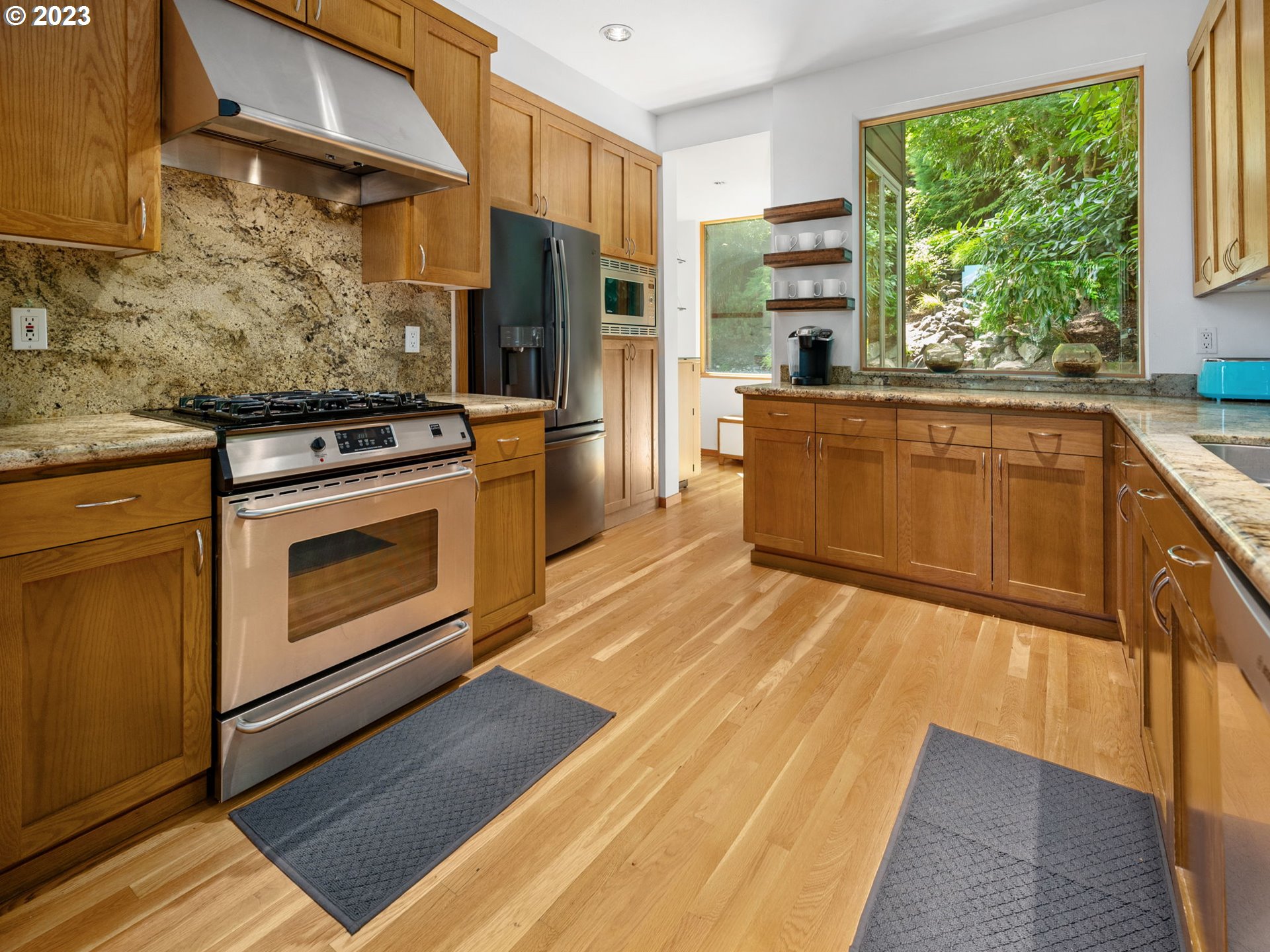 3727 Southwest Condor Lane Portland, OR 97239 - Photo 7 of 33 a kitchen with stainless steel appliances granite countertop a stove a sink and a refrigerator