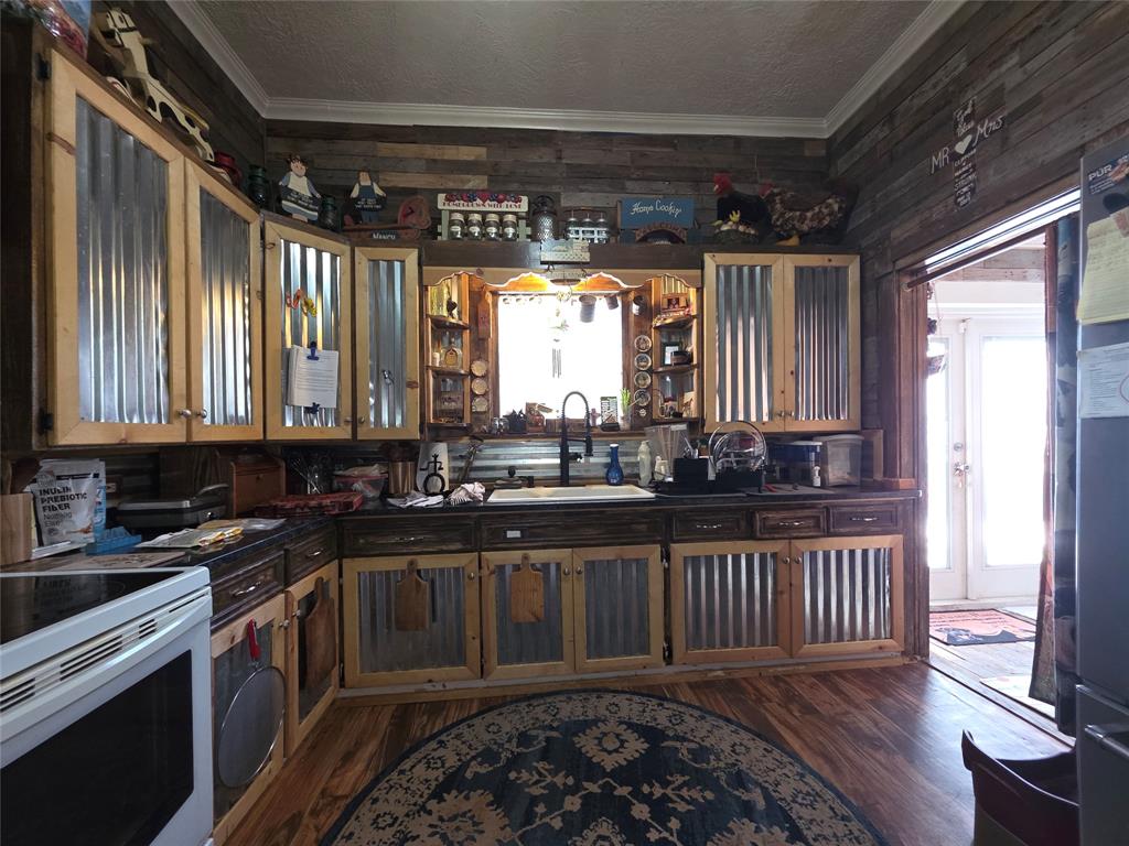 211 West Sabine Street Groesbeck, TX 76642 - Photo 12 of 40 a kitchen with a sink a window and stainless steel appliances