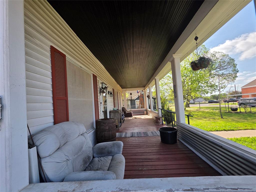 211 West Sabine Street Groesbeck, TX 76642 - Photo 2 of 40 a living room with patio furniture and a large window