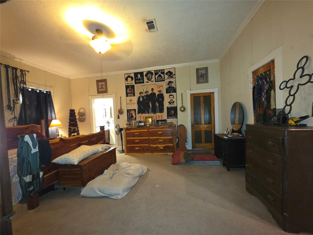 211 West Sabine Street Groesbeck, TX 76642 - Photo 22 of 40 a bedroom with furniture and a flat screen tv