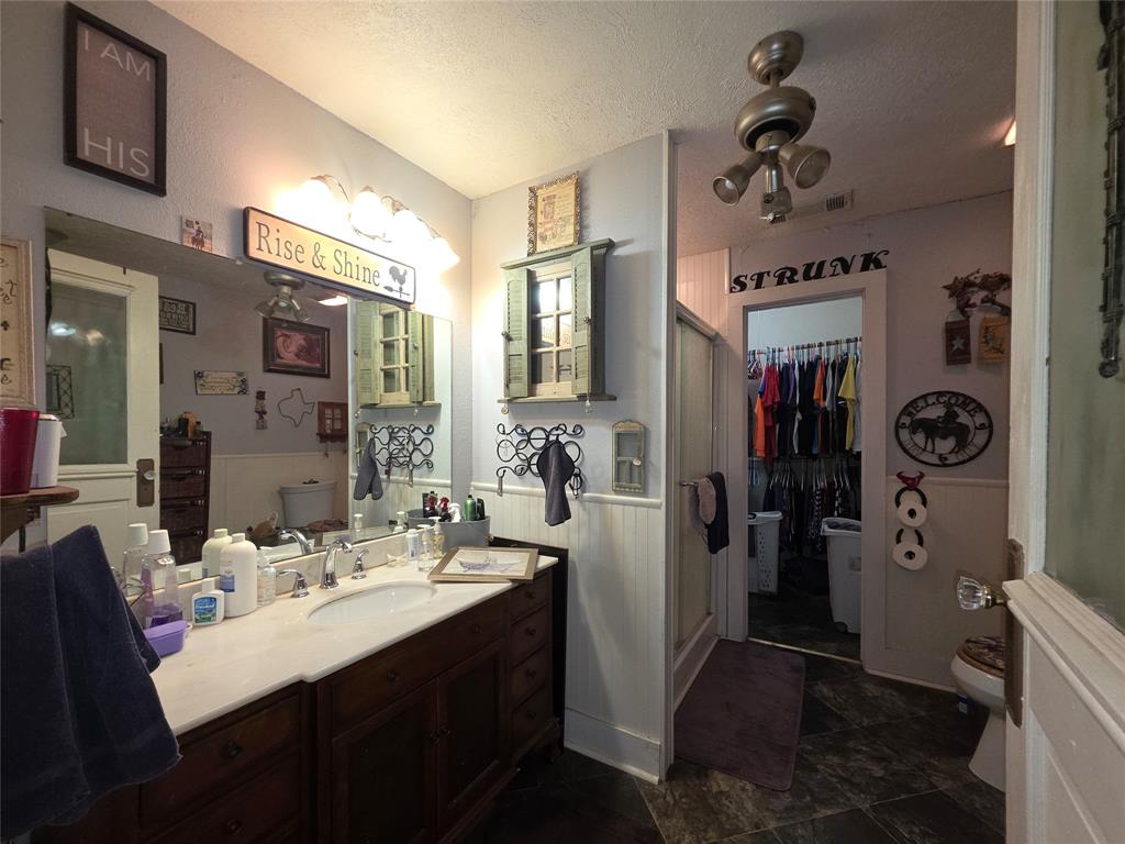 211 West Sabine Street Groesbeck, TX 76642 - Photo 27 of 40 a bathroom with a sink a mirror and shower