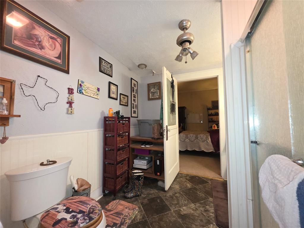 211 West Sabine Street Groesbeck, TX 76642 - Photo 29 of 40 a view of a bedroom with baby crib and lounge chair