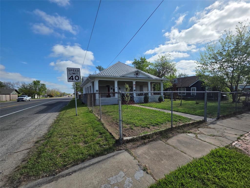 211 West Sabine Street Groesbeck, TX 76642 - Photo 30 of 40 a view of a house with a big yard plants and large trees