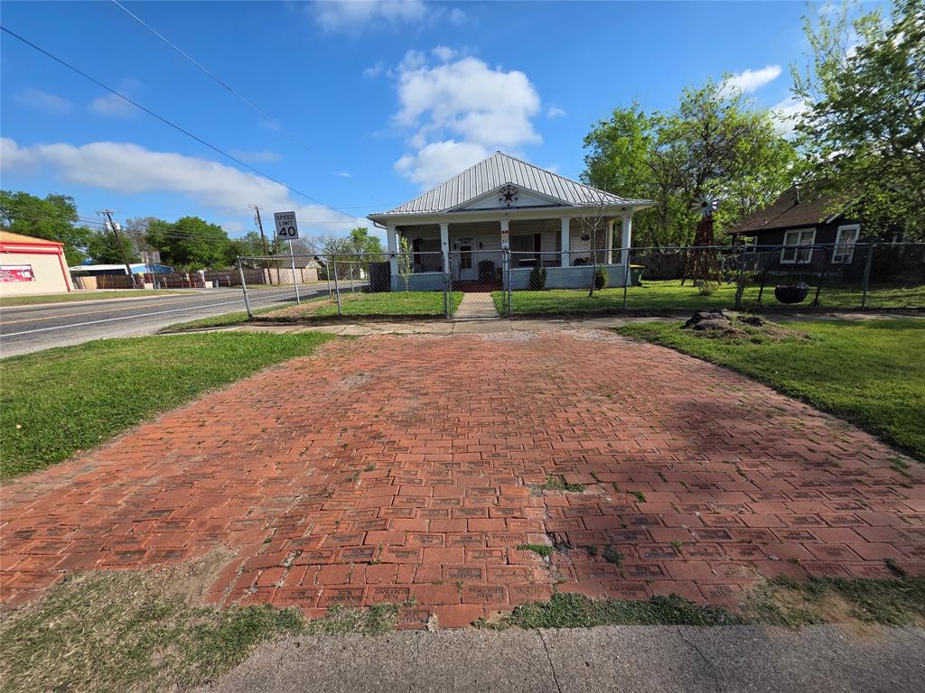 211 West Sabine Street Groesbeck, TX 76642 - Photo 33 of 40 a front view of a house with a yard