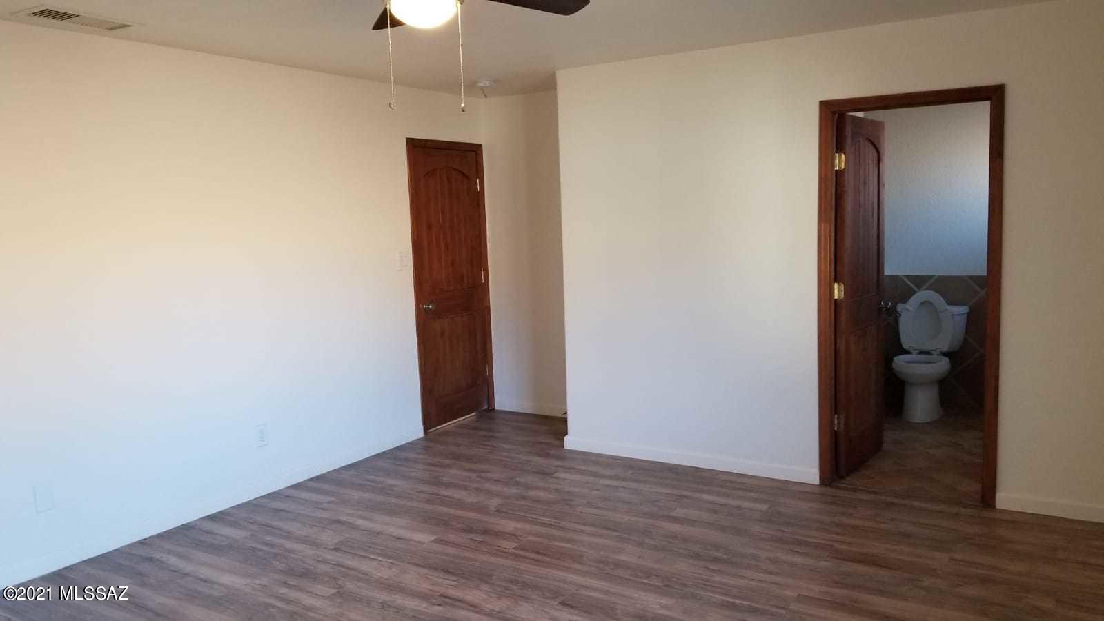 897 Via Savalza Rio Rico, AZ 85648 - Photo 22 of 27 a view of a room with wooden floor and a hallway