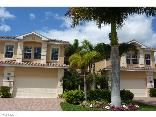 8613 Champions Point, Unit 302 Naples, FL 34113 - Photo 2 of 10 a front view of a house with a garden
