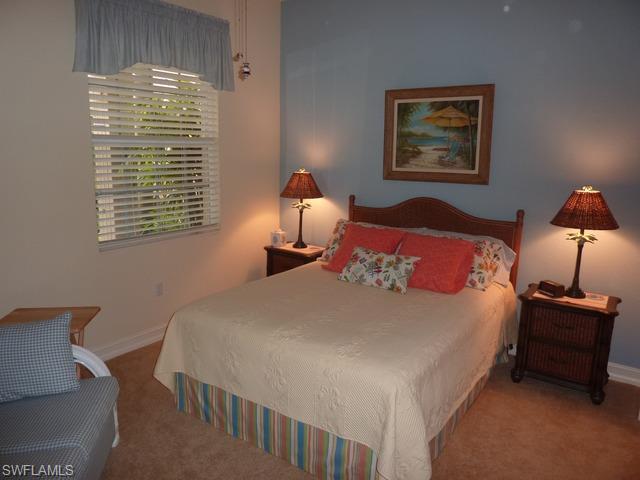 8613 Champions Point, Unit 302 Naples, FL 34113 - Photo 10 of 10 a bedroom with bed and a window
