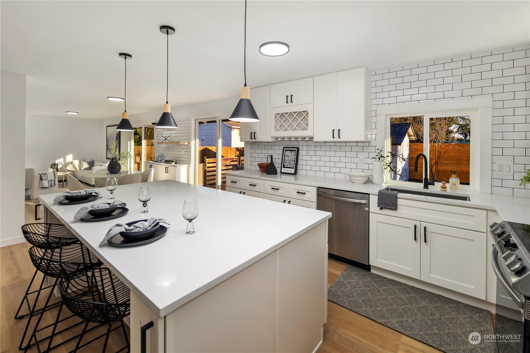 12845 Southeast 258th Street Kent, WA 98030 - Photo 16 of 35 a kitchen with stainless steel appliances a sink a stove a table and chairs