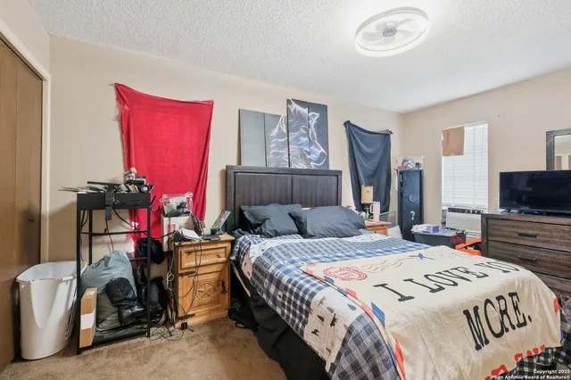 a bedroom that has a bed and a television