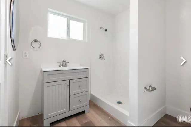a bathroom with a sink a mirror and a shower