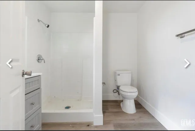 a bathroom with a toilet and a shower