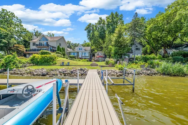 a view of a swimming pool with a patio and a yard
