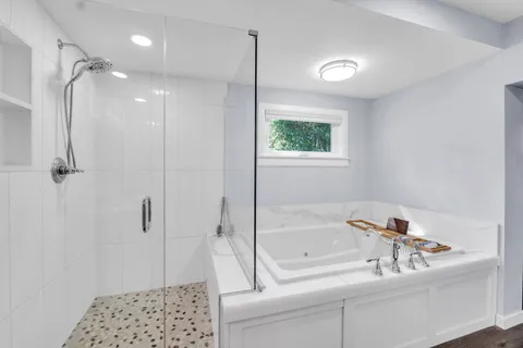 a bathroom with a granite countertop double vanity sink and a mirror
