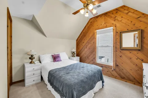 a bed sitting in a bedroom next to a window