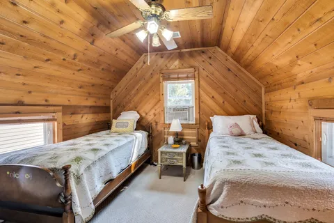 a bedroom with a bed dresser and a window