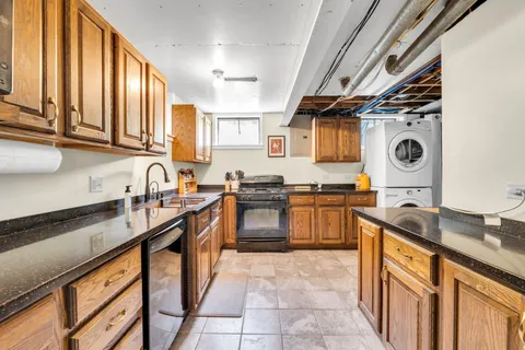 a bathroom with a granite countertop sink mirror and shower