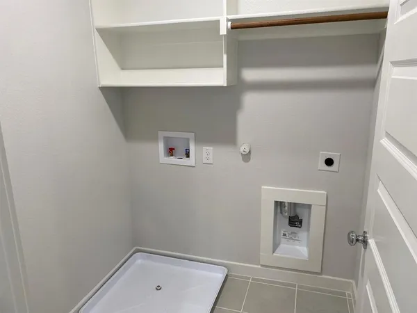a bathroom with washing machine and closet