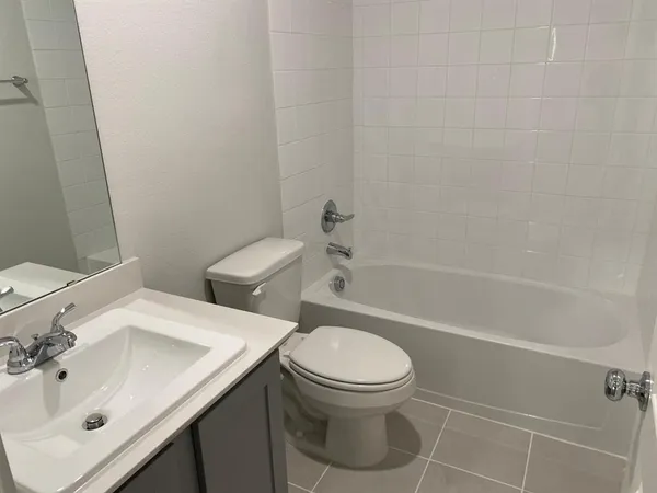 a white toilet sitting next to a bathroom sink