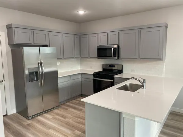 a kitchen with a refrigerator sink and microwave