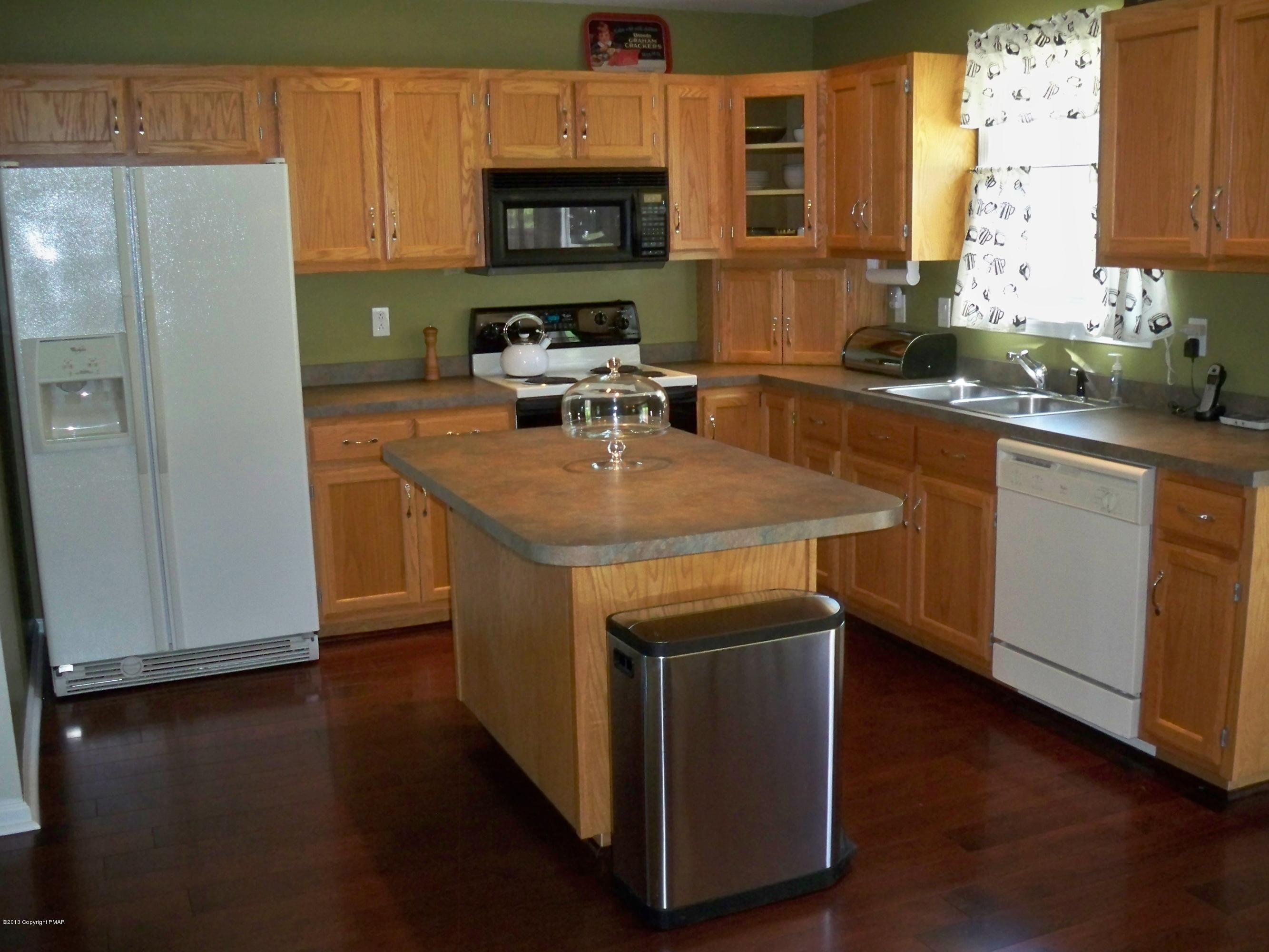 420 Blue Ridge Road Saylorsburg, PA 18353 - Photo 13 of 32 a kitchen with stainless steel appliances granite countertop a sink a stove a refrigerator a cabinets and wooden floor