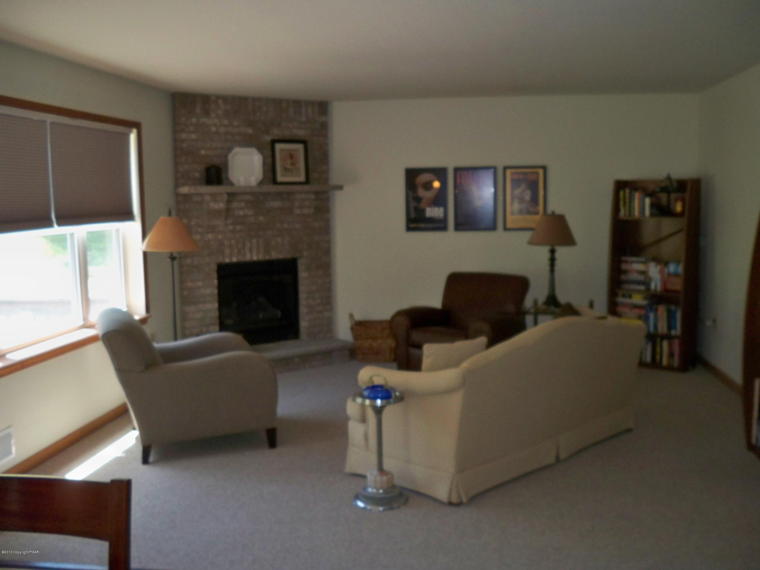 420 Blue Ridge Road Saylorsburg, PA 18353 - Photo 15 of 32 a living room with furniture and a fireplace