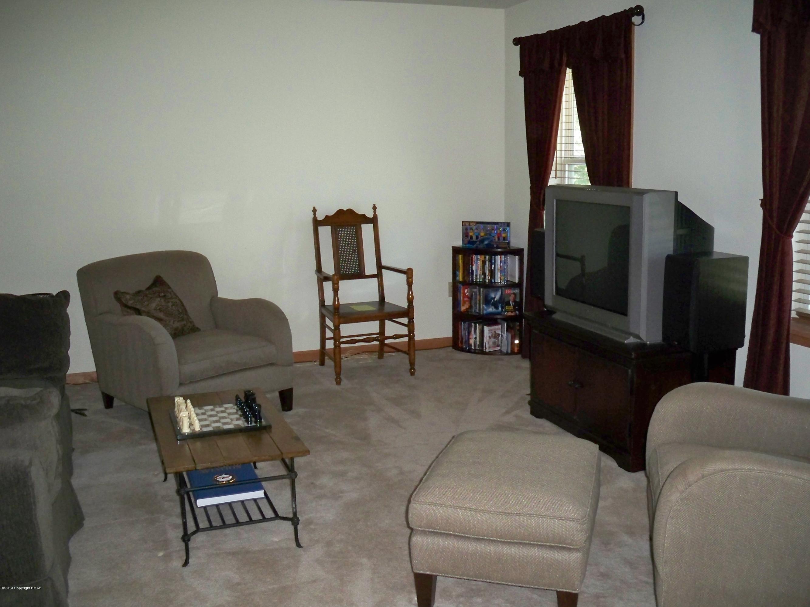 420 Blue Ridge Road Saylorsburg, PA 18353 - Photo 18 of 32 a living room with furniture and a flat screen tv