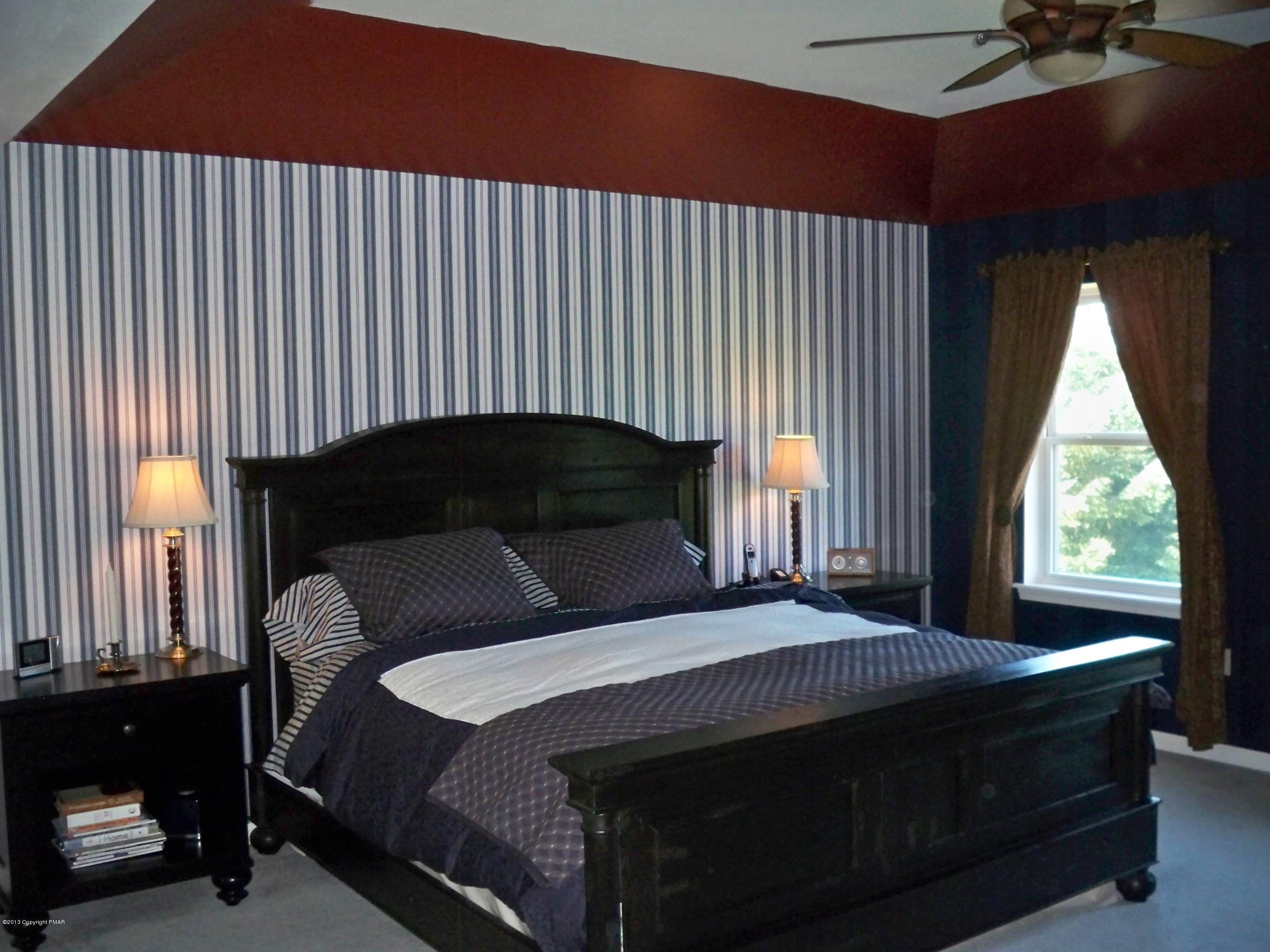 420 Blue Ridge Road Saylorsburg, PA 18353 - Photo 21 of 32 a bedroom with a bed lamp and window