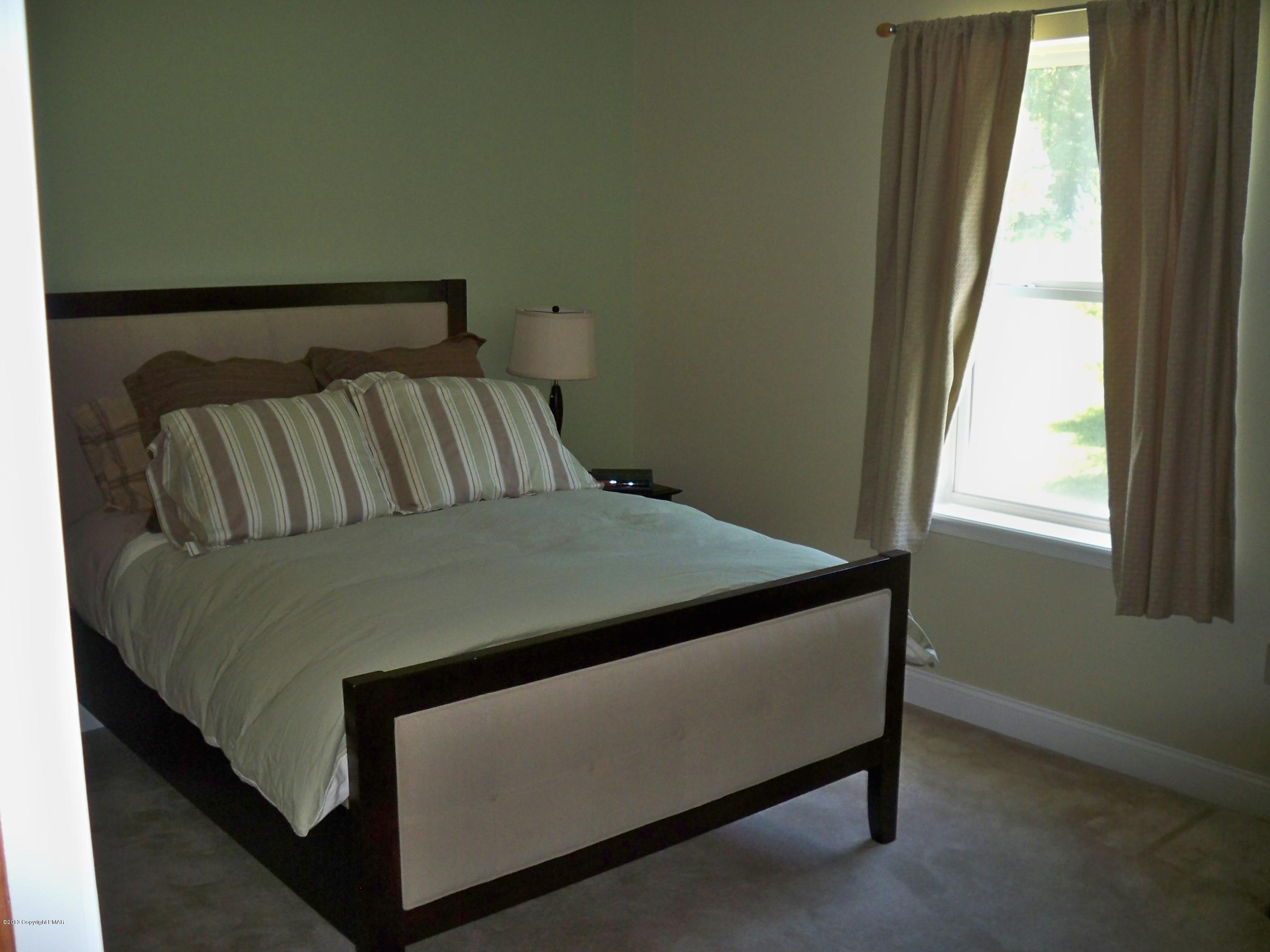 420 Blue Ridge Road Saylorsburg, PA 18353 - Photo 27 of 32 a bed sitting in a bedroom next to a window