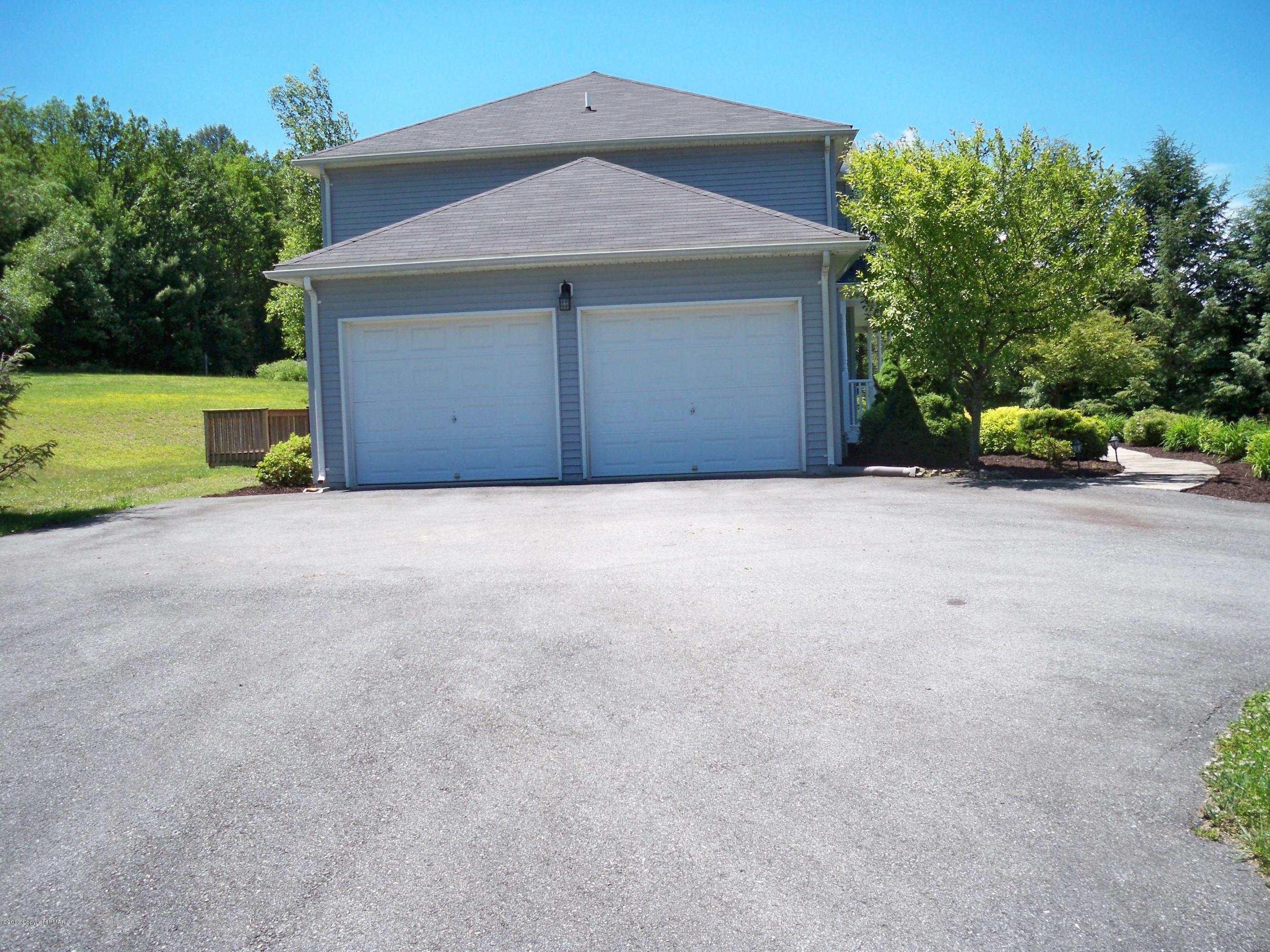 420 Blue Ridge Road Saylorsburg, PA 18353 - Photo 7 of 32 a front view of a house with a yard and garage