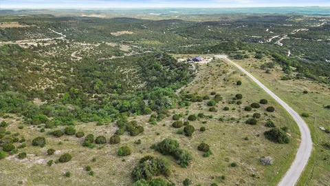 a view of a green field with lots of bushes