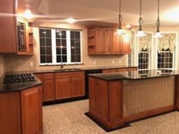 97 Franklin Street Reading, MA 01867 - Photo 2 of 6 a kitchen with stainless steel appliances granite countertop a stove a sink and a refrigerator