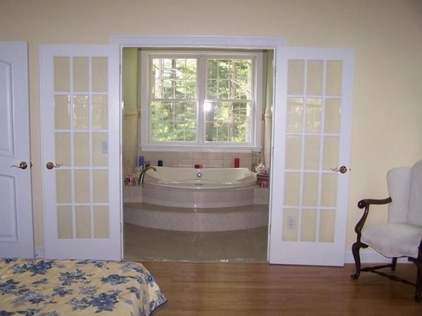 97 Franklin Street Reading, MA 01867 - Photo 4 of 6 a bathroom with a tub and chair