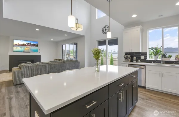 a large kitchen with stainless steel appliances a large island in the center