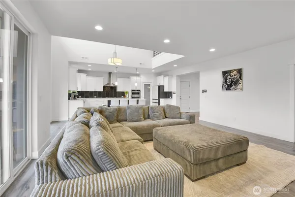 a living room with furniture and kitchen view