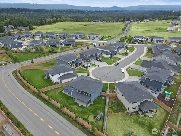 an aerial view of residential houses with outdoor space and river