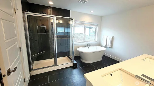 a view of bathroom with a tub and shower