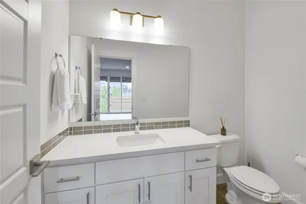 a bathroom with a sink toilet and vanity
