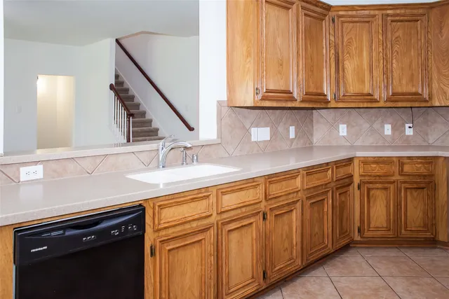 an empty room with a chandelier fan and a view of a fan