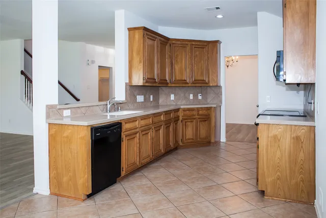 a bathroom with a granite countertop bathtub shower and toilet