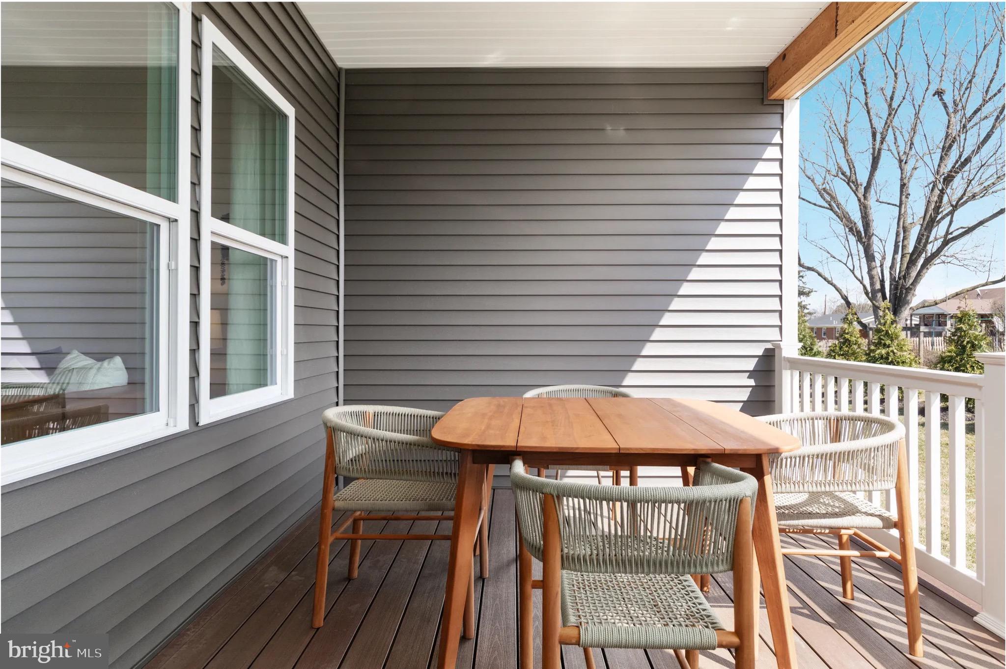 4 Bowens Run Road Bealeton, VA 22712 - Photo 11 of 21 a view of a patio with a table and chairs under an umbrella with wooden floor