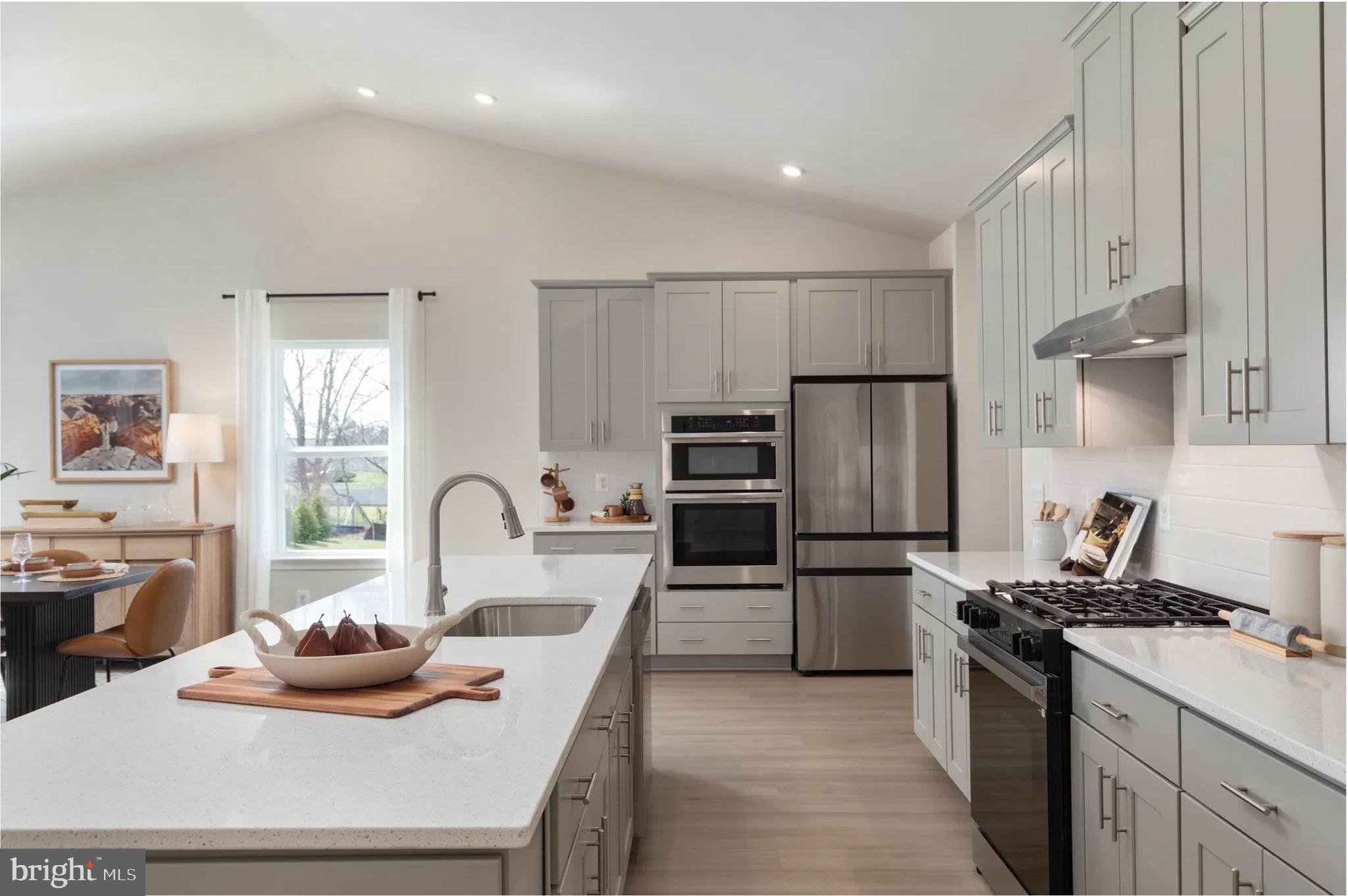 4 Bowens Run Road Bealeton, VA 22712 - Photo 6 of 21 a kitchen with kitchen island a stove a sink and a refrigerator